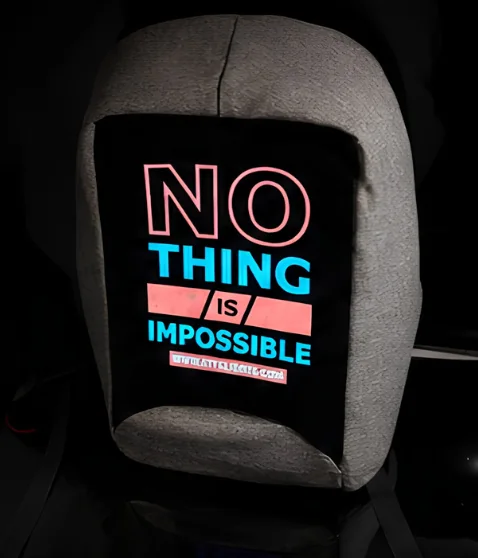 A car headrest with a glowing STYELIGHTS™ Smart “Nothing is impossible” graphic